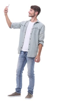 in full growth.young man taking selfie.isolated on white background.