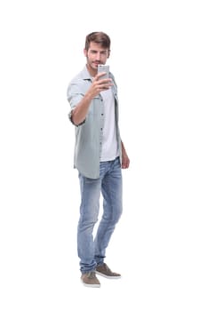 in full growth.young man taking selfie.isolated on white background.