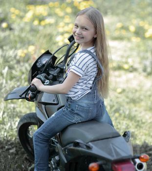 little biker girl riding her motorcycle as a symbol of freedom, adventure and travel