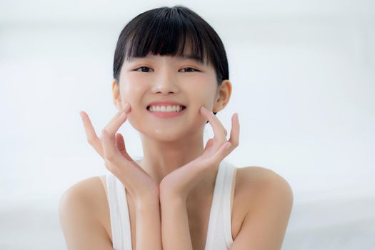 Beautiful young asian woman makeup of cosmetic, girl hand touch cheek on face and smiling attractive, facial of beauty perfect skincare with wellness and wrinkle, skin care and health concept.