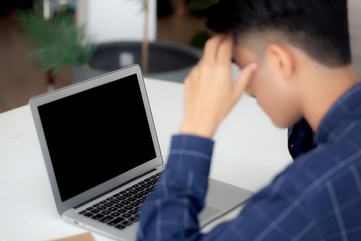 Young asian business man headache during working on laptop computer display blank screen with deadline at home, businessman with failure exhausted, stress and worried, frustrated and unsuccessful.