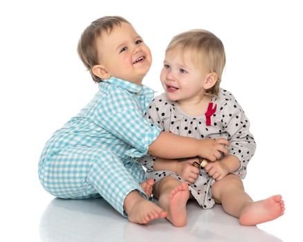 Toddler boy and girl, cute hugging in studio on a white background. The concept of a harmonious development of a child in the family, a happy childhood. Isolated.