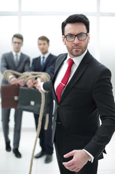 close up.businessman drags his colleagues .business metaphor