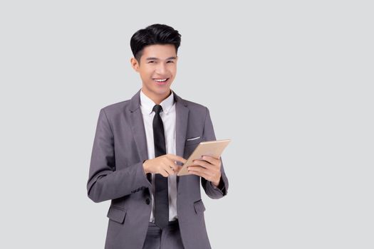 Portrait young asian business man in suit standing using tablet computer to internet isolated on white background, businessman confident touch screen digital pad with success, communication concept.