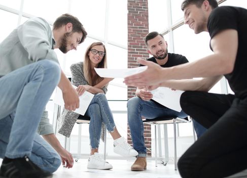 Business people sitting in office working with document having discussion.