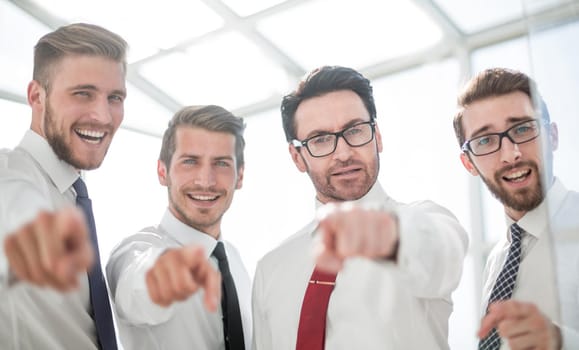 close up.confident business team pointing to you.the concept of choice