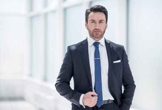 serious businessman standing near an office window.photo with copy space