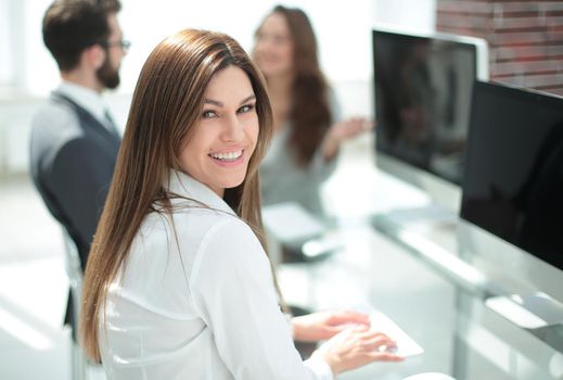 young employee sitting at his Desk . photo with copy space