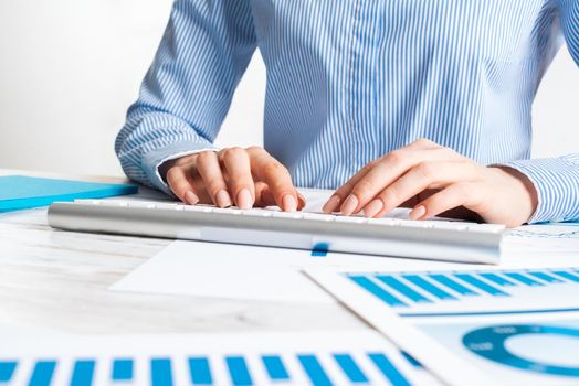 Manager typing on computer keyboard at wooden desk. Strategy planning and banking. Financial analyst working in office. Business accounting and project management. Close up woman hands on keyboard