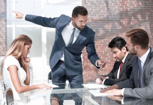 strict boss talking to employees at a business meeting . business concept