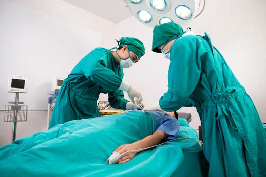 Group of team doctor and surgeon doing surgery with patient in the operation at hospital, medical and emergency, specialist and assistant rescue patient with expertise, surgical and health.
