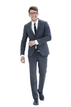 in full growth. the young businessman confidently goes forward .isolated on light background