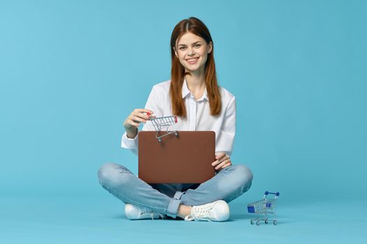 woman with laptop learning internet online education blue background. High quality photo