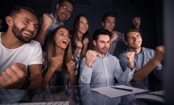 happy business team looking at computer monitor. the concept of overtime