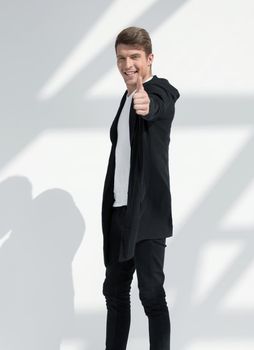 in full growth.smiling young man pointing at you.isolated on light background