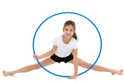 Happy little girl playing with a hoop. The concept of a happy childhood. Isolated on white background.