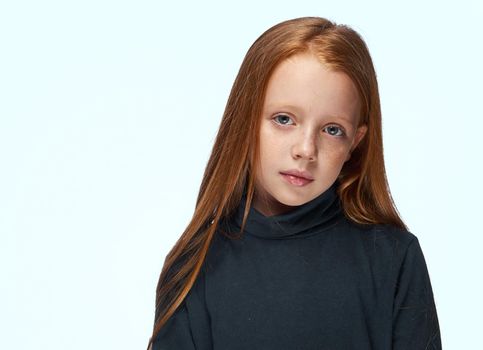 red-haired girl in a black sweater planning close-up. High quality photo