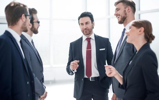 business colleagues discussing a hundred and something standing in the office.the concept of teamwork