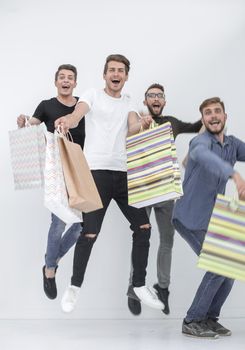 Full length image of happy team of guys rejoice with packages and looking at camera on gray background