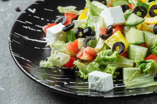 Greek Salad with Cucumeber, Kalamata Olives, Feta Cheese, Juicy Cherry Tomatoes and Fresh Basil. Home made food. Concept for a tasty and healthy vegetarian meal. Top view. Copy space.