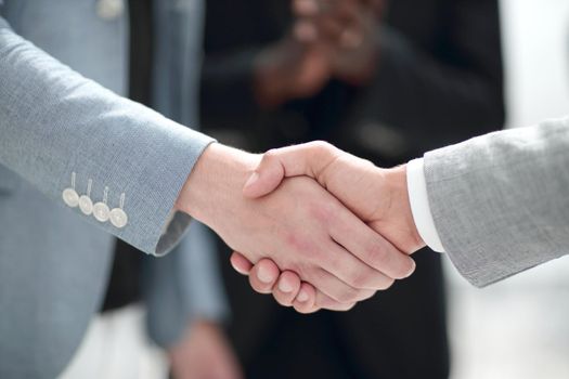 Two confident businessman shaking hands during a meeting in the office, success and partner concept.