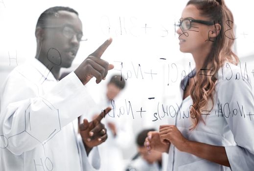 Attractive young scientist pipetting and microscoping in the life science research laboratory