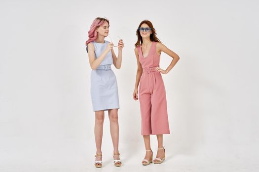two women in fashionable clothes posing model decoration. High quality photo