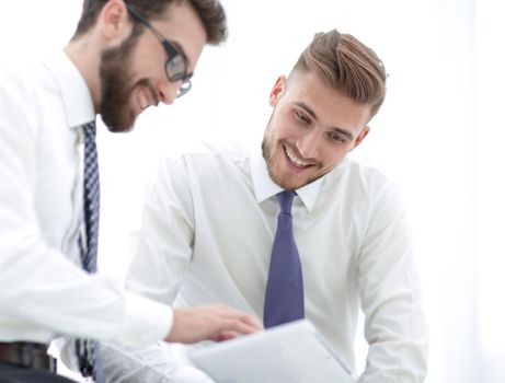 close up.business colleagues looking at the digital tablet screen.isolated on a light background