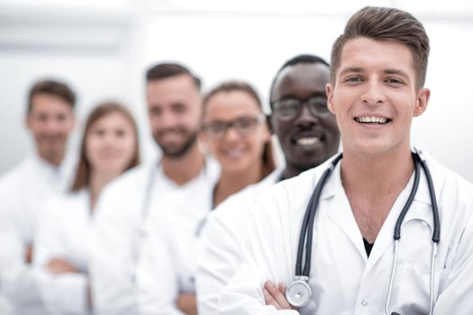 Team of young professional doctors standing together in laboratory, posing with arms crossed