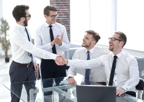 business colleagues shaking hands in the workplace.photo with copy space