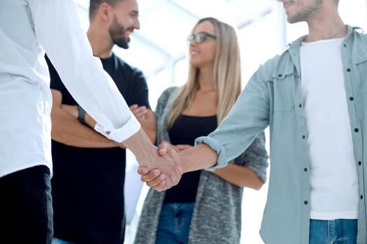 Lawyer handshaking with client in office, closeup