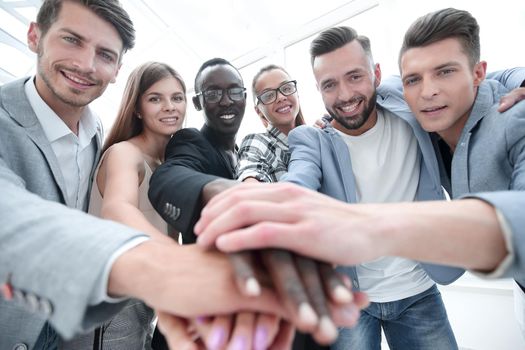 Mid section of businesspeople with hand stacked in office