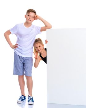 A boy and a girl near a white banner on which you can write a text. The concept of advertising a variety of goods and services. Isolated on white background.