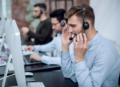 employees with a headset in the workplace in the business center.business concept