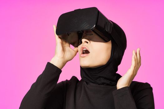 muslim woman wearing virtual reality glasses entertainment technology device. High quality photo