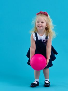 The little girl is catching the ball. The concept of relaxation, fitness and gymnastics.