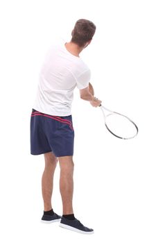 rear view. a young man with a tennis racket. isolated on white background