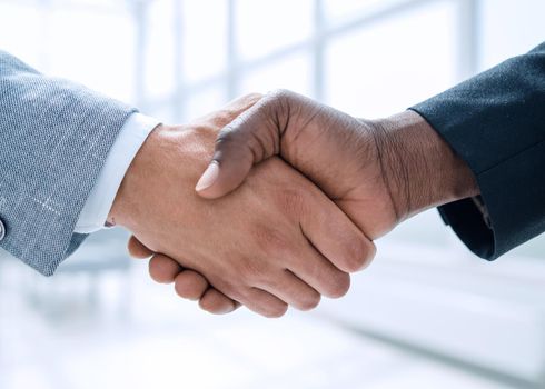 Business people closing a deal and handshaking at the office