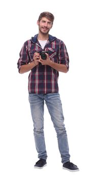 full-length .a handsome young man with a camera.isolated on white background.