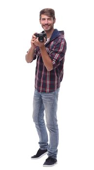 full-length . smiling young man with a camera.isolated on white background.