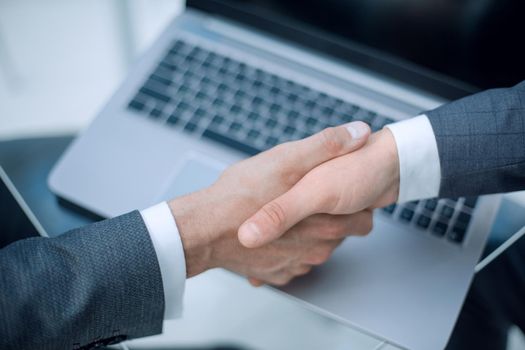 close up.handshake business partners over the Desk. business and technology