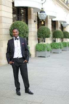 Afro american successful man wearing suit and standing outside. Concept of black businessman.
