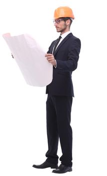 in full growth. businessman looking at sketches of a new project. isolated on white background