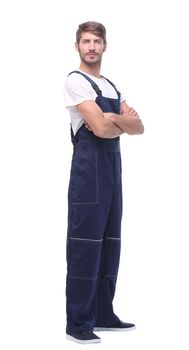 in full growth. smiling man in blue overalls. isolated on white background