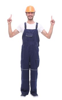 in full growth. smiling man in overalls pointing somewhere up. isolated on white background