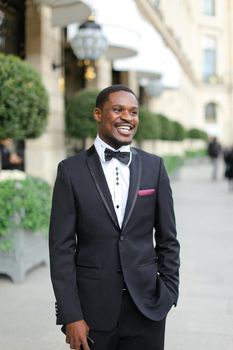 Afro american man wearing suit and standing outside. Concept of black businessman.