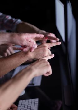 business team pointing their fingers at the computer screen .photo with copy space