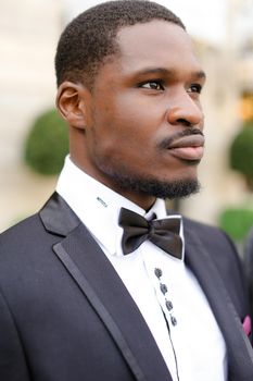 Portrait of afro american man with butterfly tie. Concept of black businessman.