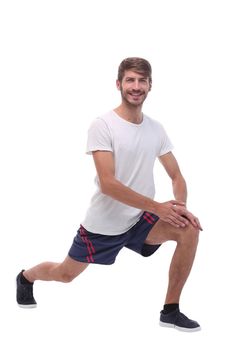 Full length.active male performs squats with straight arms. isolated on white background