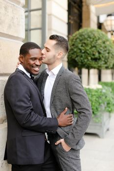 Afro american gay hugging european man outdoors. Concept of lgbt and same sex couple.